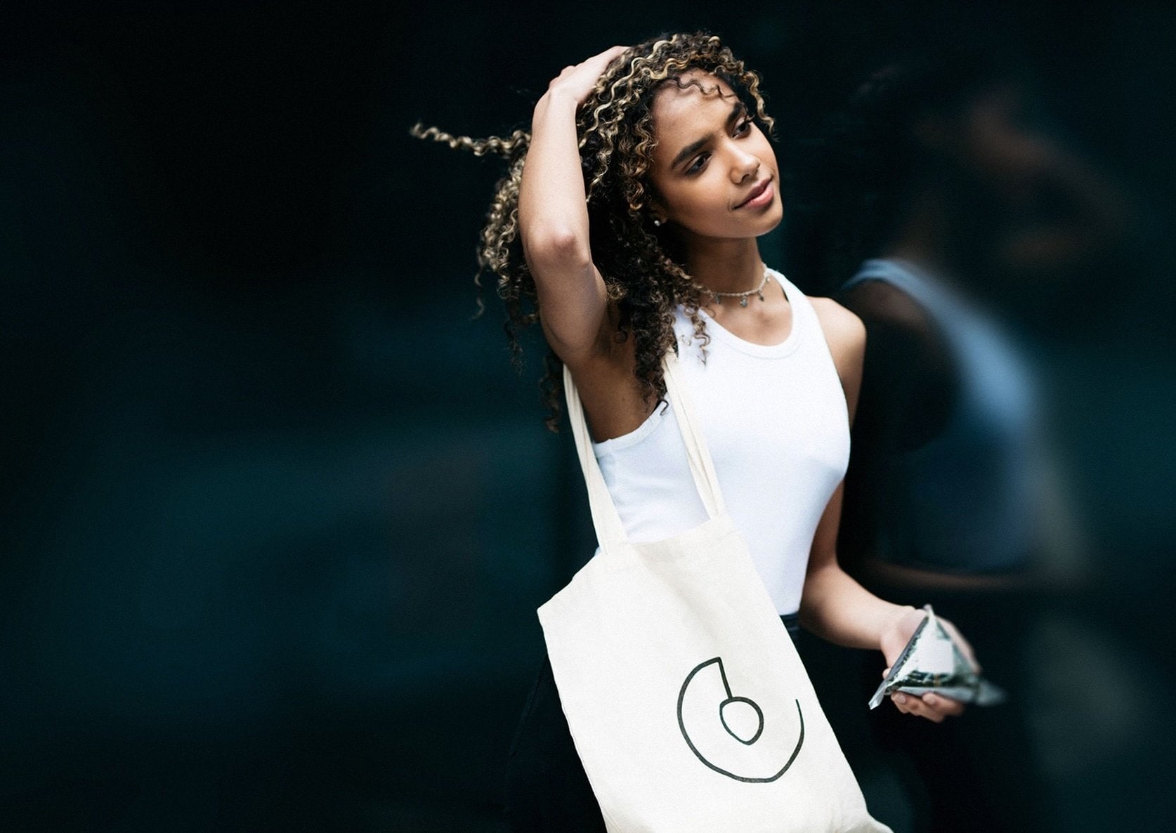 A woman carrying a CombiniCo. tote bag