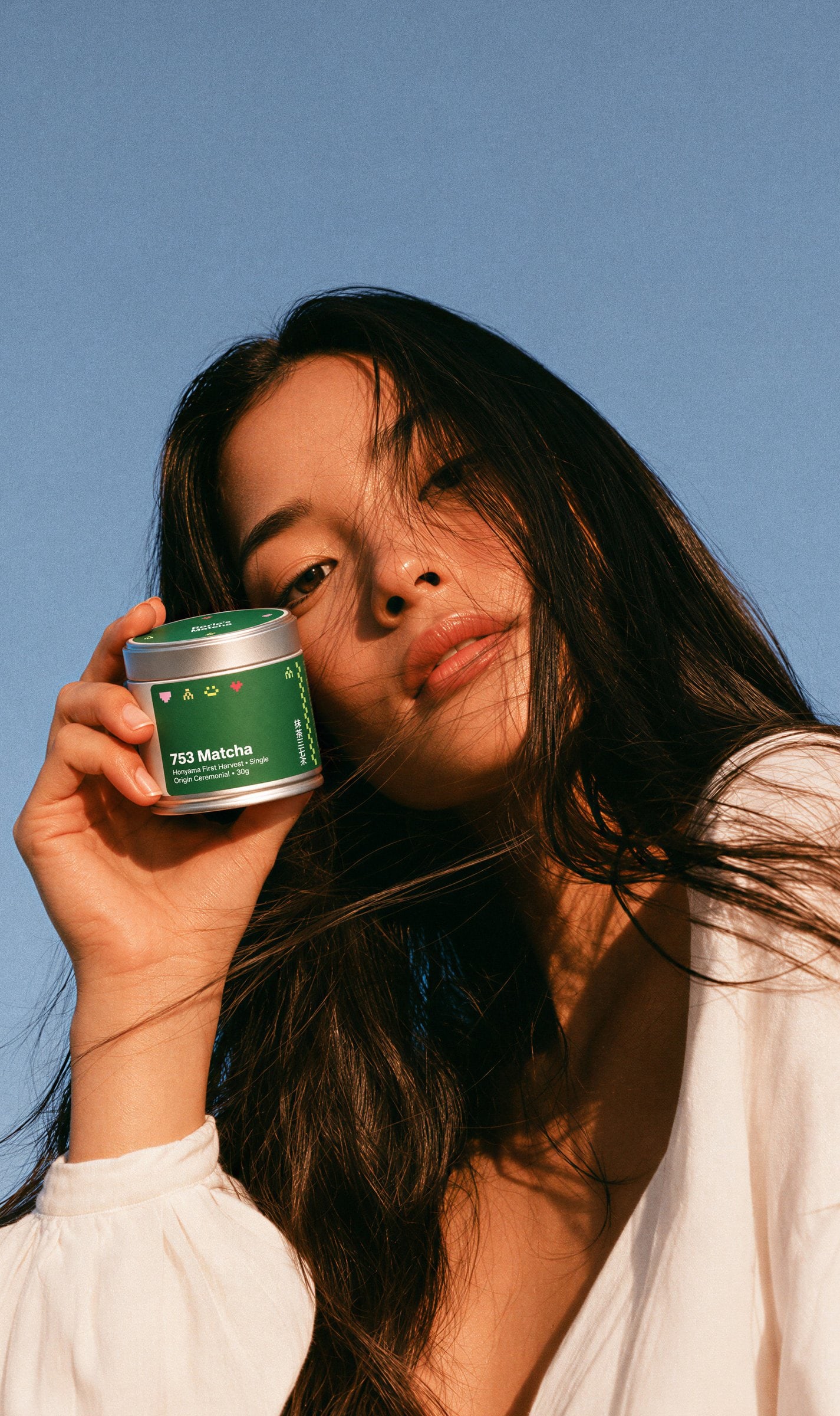 A woman holding a green Marlo’s Matcha tin