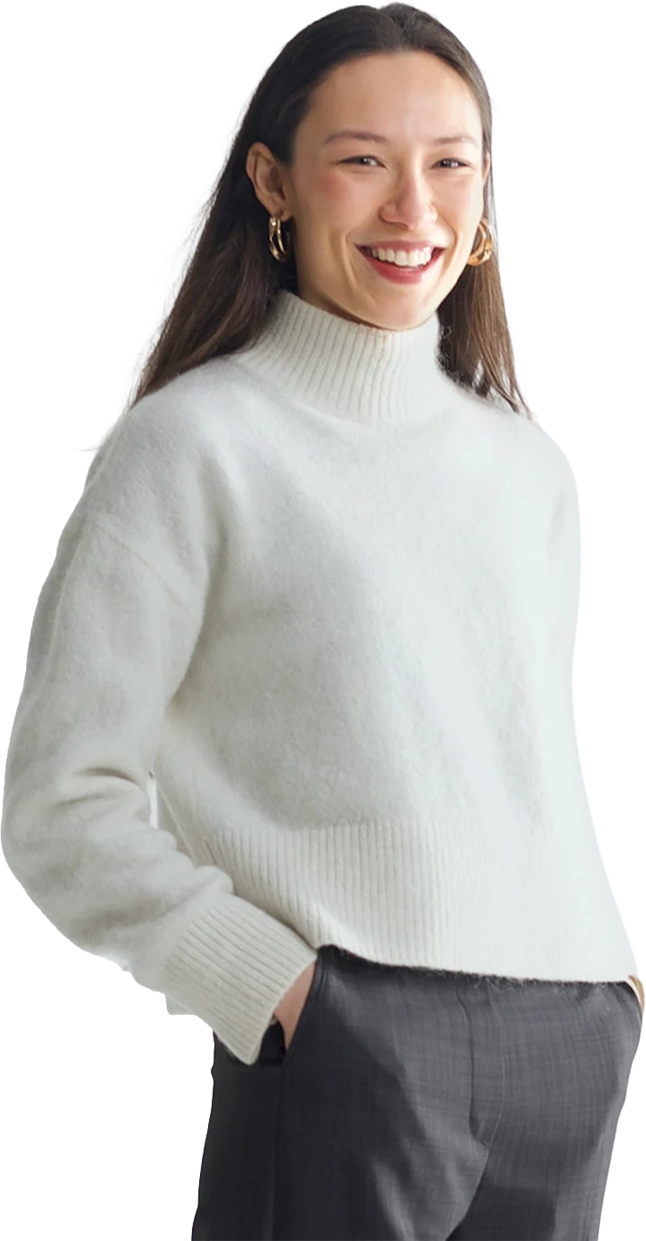 A member of the Longson Studio team, smiling, in a white jumper